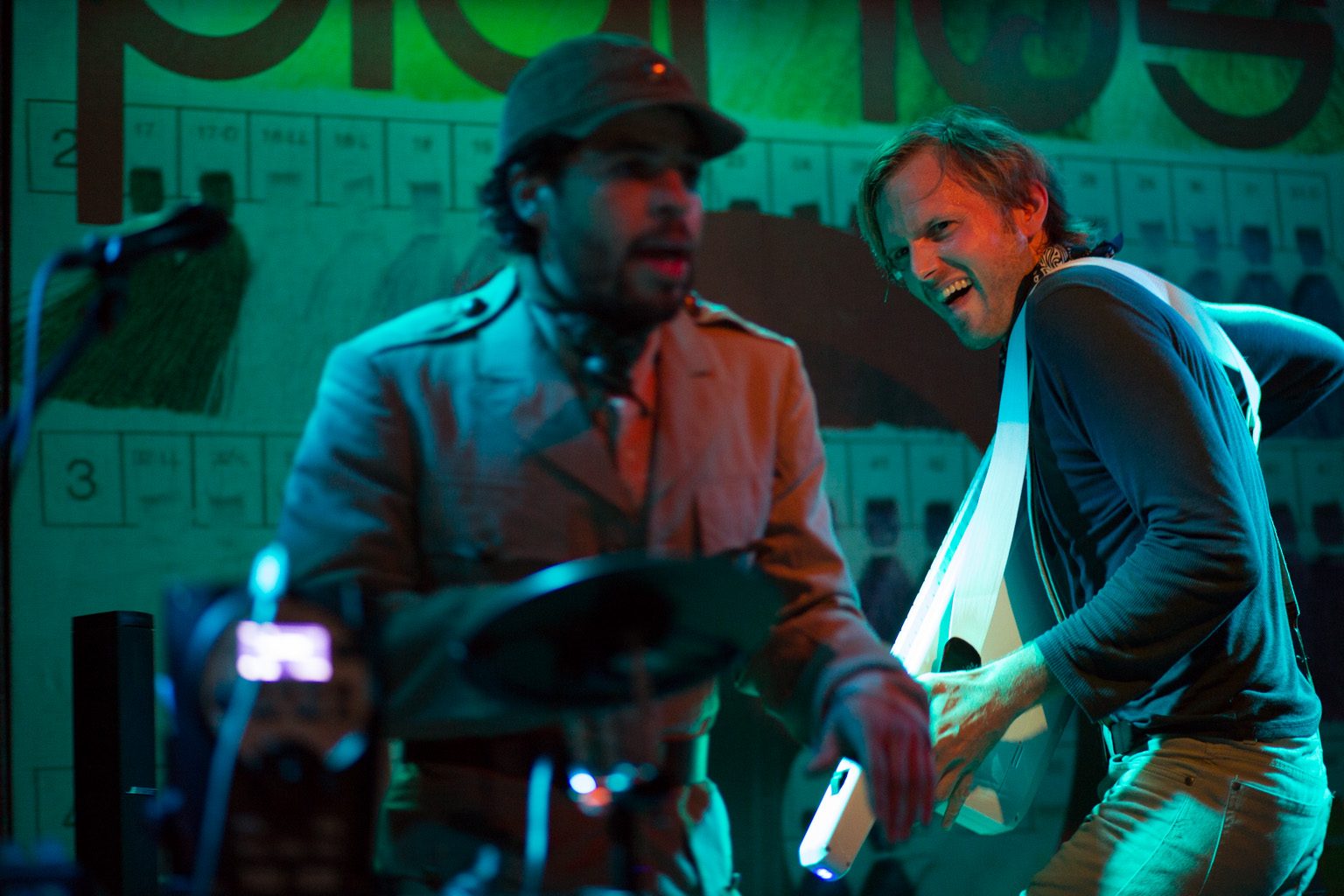 Banjoshi on stage under purple lighting